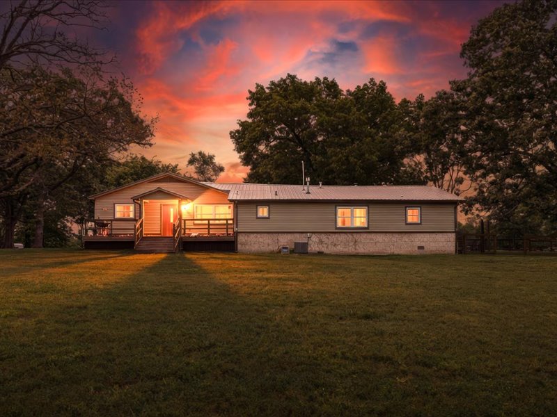 Located just off AR-102, only 5 mins to Centerton & 20 mins to the new Walmart HQ. This stunning property offers the perfect mix of convenience & country living. The land is truly special w/ a blend of open pasture, flat buildable ground, rolling hills, & wooded acreage. Ideal for a hobby farm, multi-generational homestead, business use, hunting property, or 1031 investment opportunity. Shooting range onsite plus a ready-to-build setup on the SW corner w/ septic, water, & electric already in place. Home features 4 beds, 3 baths, & two living areas w/ real hardwood floors. New fresh interior paint & cabinetry, carpet, blinds, & AC in 2025. Remodeled in 2012 w/ granite countertops, stainless steel appliances, updated bathrooms, fixtures, & siding. A 60x40 insulated shop w/ concrete floors, office, storage space, wood stove, & two 14’ doors. The 30x60 shop is htd/cooled w/ mini-splits. Barn w/ lean-to for equipment. Two RV hookups onsite. Fenced. Gated entrance. A rare property w/ endless possibilities!