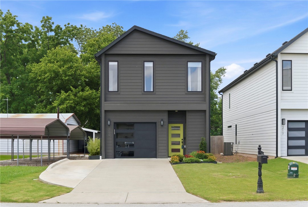 Experience the perfect blend of modern style, energy efficiency, and an unbeatable location just one block from the Razorback Greenway! This boutique-style row home offers it all. Open-concept main level features high ceilings and large windows that flood the main living area with natural light. The kitchen features granite countertops, Energy Star appliances, and an 8-foot walk-in pantry with unparalleled storage.
Upstairs, you will find a highly functional layout with all 3 bedrooms and the laundry room conveniently situated on the second floor. 
This home features an upgraded heat pump, smart thermostat, LED lighting, and a dedicated 240V EV charging outlet in the garage. The extra-deep 0.35-acre lot provides an expansive backyard, complete with a storage shed. 
Contemporary finishes, certified energy savings, zero HOA fees, and just a short walk to all the restaurants and entertainment downtown Rogers has to offer. This home checks every box. Act fast and lock in your slice of downtown Rogers living today!