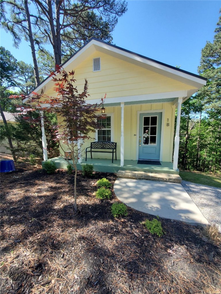 Bright and cheerful cottage boasts a treehouse view of the private woods and comes fully equipped for your full-time home or the perfect vacation hub. Ask your Realtor about the availability of a LOW 4.75% interest Owner Financing alternative. This charming cottage is designed to focus the Great Room towards the private Balcony view at the rear of the cottage while enjoying quiet comfort and privacy. Energy efficient as a benefit of super insulated new construction plus economical tankless water heater. Fully turn key, city code compliant, move-in ready. All new. Never lived in. This large lot boasts 100 feet of street frontage and ample off-street parking. New, full size appliances covey, & a combo washer/dryer. Swing open the back door to the spacious covered balcony porch designed to be easily enclosed in screen or glass. 3/4 mile walk to trolly stop. Just minutes from downtown Eureka Springs with quick access to excellent restaurants, art galleries, shopping centers, and only about 15 minutes from Beaver Lake.