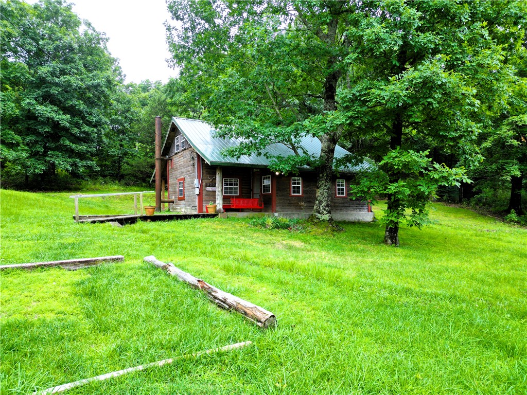 Tucked away in the peaceful hills of Chester, Arkansas, 9005 Rackley Mountain Road offers the quiet retreat you have been looking for. This quaint 3 bedroom, 1 bath cabin sits on around 4 beautiful acres, giving you room to breathe, relax, garden, explore, or simply enjoy the slower pace of country living. Whether you are looking for a weekend getaway, a full-time residence, or a private escape from the busyness of town, this property has the charm and setting to make it special. The cabin offers a warm, simple layout with a cozy feel, surrounded by nature and the privacy that only acreage can provide. Imagine mornings with coffee on the porch, evenings under the stars, and weekends spent enjoying the outdoors. Conveniently located near the natural beauty of the Boston Mountains, this property is ideal for anyone wanting peace, privacy, and a true Arkansas cabin experience.