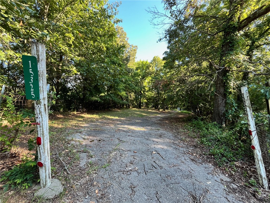 Great site for building a home - partially wooded, hillside property with a level place for building.  Enjoy country living, close to town on a well maintained county gravel road.  Water and electric are already on the property as is a septic system from a previous trailer home.