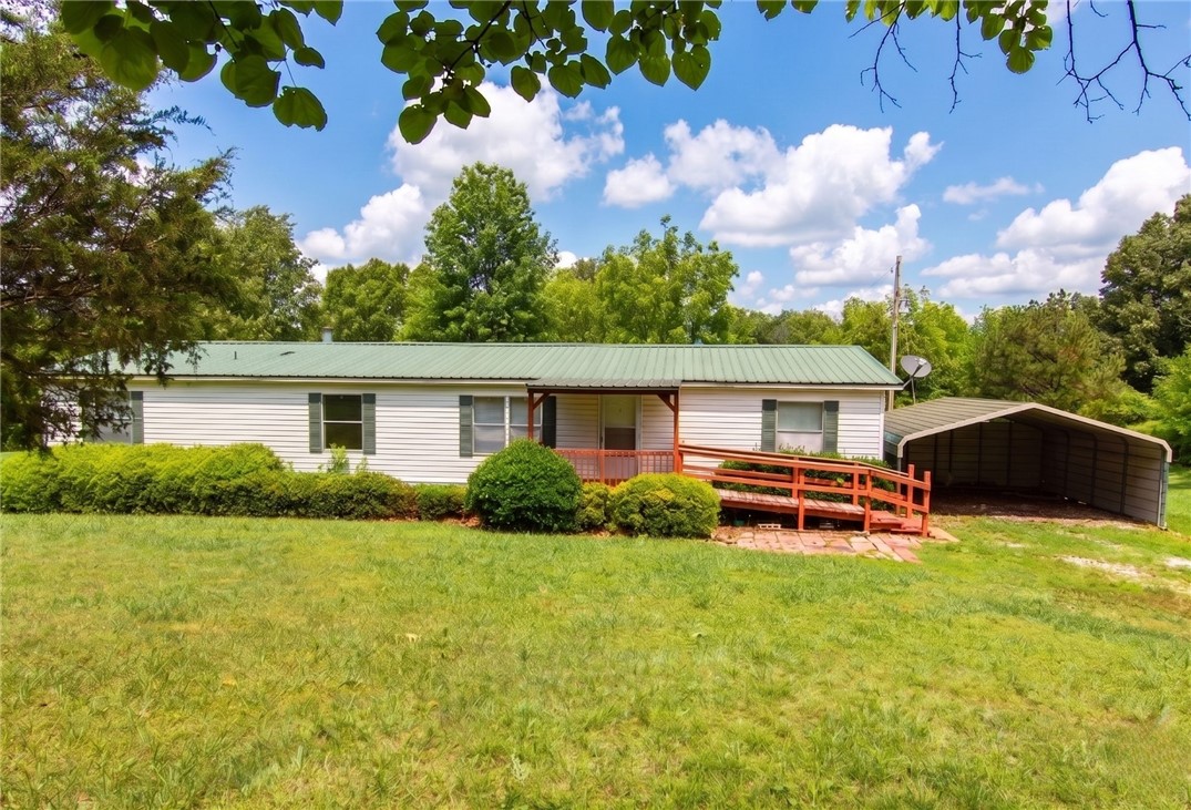 Rare find in Western Grove, AR! This sprawling 4-bedroom, 2-bathroom manufactured home offers over 1,900+ sq ft of spacious living area, perfectly situated on 4.46 private acres of beautiful, plush green grass and stunning mature shade trees. Enjoy the ultimate peace and serenity of a country setting while remaining exceptionally close to town conveniences and approximately 6 miles from the Buffalo River. The expansive layout provides abundant room to grow, making it perfect for families, a dedicated home office, or a peaceful mini-farm retreat in the Ozarks.
All information and details in this listing, including square footage and acreage, are deemed reliable but not guaranteed and must be independently verified by the buyer.