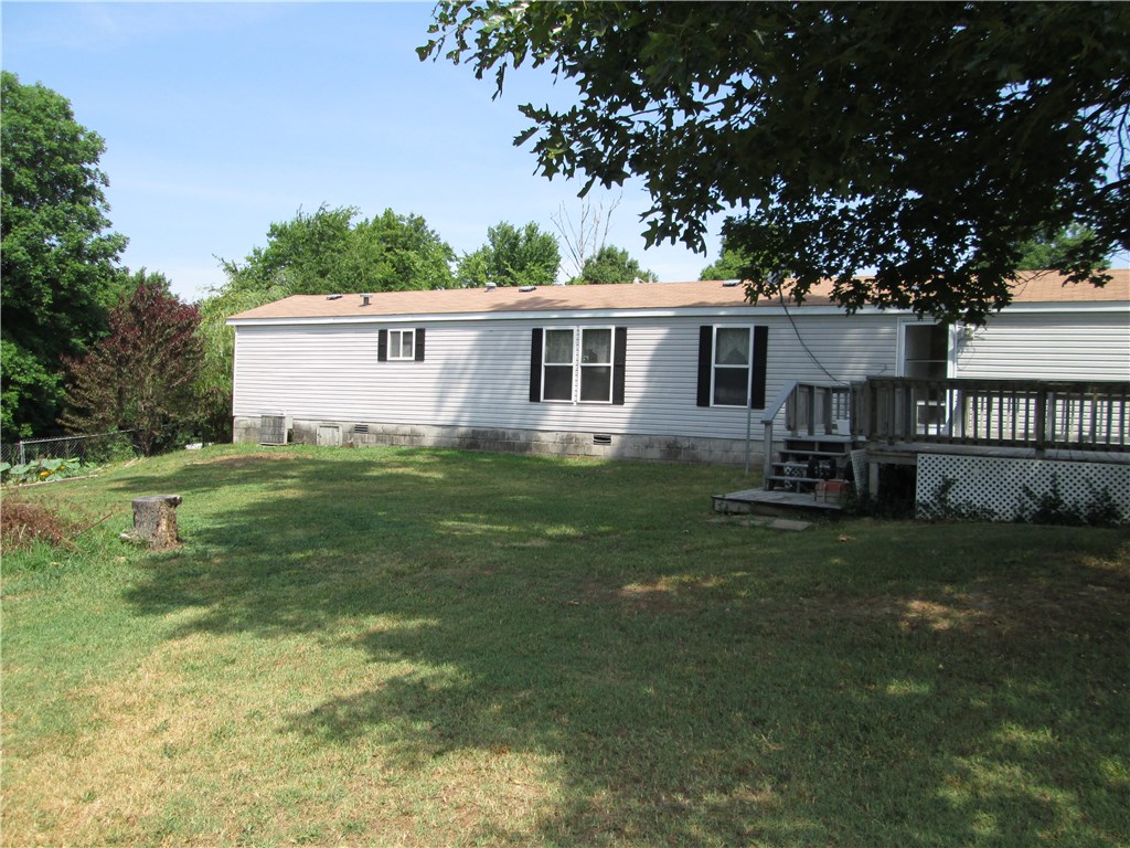 Cute home with spacious living room, new laminate flooring in kitchen, split floor plan, cute kitchen, tons of windows for natural light, 2 full bathrooms, stand up shower in master , spacious yard, storage, covered front porch, extended deck in back yard. Home sits on permanent foundation.