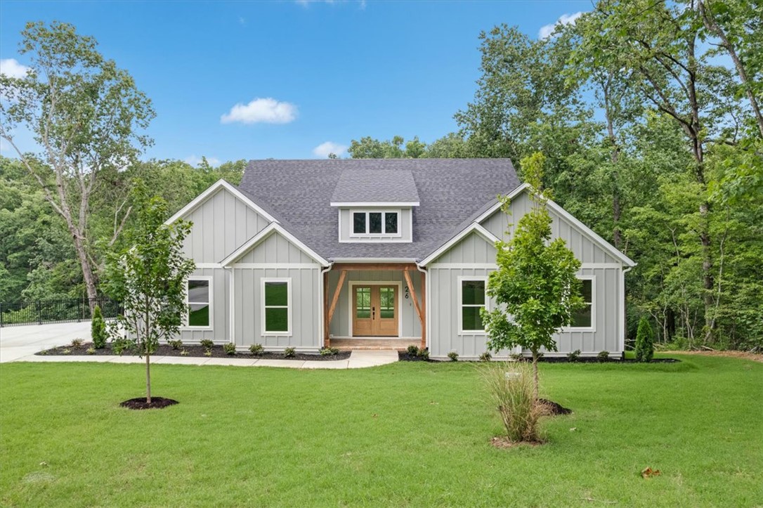 Luxury meets exceptional craftsmanship in this custom-built home on .71 acres at the end of a peaceful cul-de-sac, backing to POA land for unmatched privacy and wooded views.  Inside, you'll find gorgeous white oak flooring, custom built-ins, designer butler's pantry, spa-inspired tiled baths, powder room, spacious laundry room, oversized drop zone, and a designated office. The chef's kitchen features a ZLINE dual-fuel 6-burner range, pot filler, and premium Delta fixtures.  Designed with quality beyond code, the reinforced foundation, sealed crawl space, sound-insulated walls, Schluter waterproof shower systems, and enhanced HVAC airflow provide lasting comfort and peace of mind. Enjoy the expansive 30' deck, oversized epoxy-finished side-entry garage with smart technology, steel-fenced driveway, and a prime location just steps from Highlands Golf Club and a mere 5 minutes to I-49  Too many features and upgrades to list, come see for yourself!