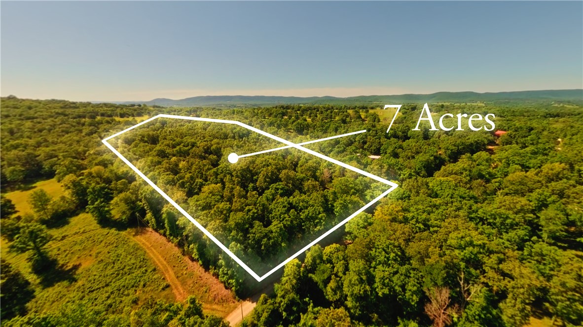 Nearly 7 acres in Marion County, Arkansas, less than a mile from access to the famous White River. This private and peaceful property offers an ideal setup for camping, recreation, investment, or building your Ozarks getaway. Conveniently located near Highway 62 and only a quarter mile down a well-maintained gravel road, the property is just minutes from Cotter, Big Spring Park, and only five minutes from Walmart. Improvements already onsite include city water, septic, and 200 amp electric service. The RV pad features sewer, water, and 110/30/50 amp hookups, perfect for RVs or campers. Additional features include two frost-free hydrants, a brand-new driveway, trails throughout the property, fencing on two sides, and a large cleared private area with a prepared pad ready for your future home, cabin, or shop.