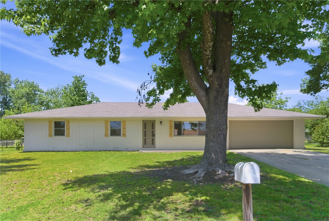This fully updated 3-bed, 2-bath home in Rogers is loaded with upgrades and completely move-in ready. The exterior and interior have been freshly painted, new luxury vinyl plank flooring flows throughout, and a stylish accent wall adds a modern touch. The kitchen shines with quartz countertops, a tile backsplash, all-new stainless steel appliances, and a new lighting package. Both bathrooms feature quartz countertops, tile, and all-new fixtures and toilets — the primary bath includes a fully tiled stand-up shower. Two of the three bedrooms offer walk-in closets. Step outside to a screened, roofed sunroom — perfect for year-round relaxing — plus a storage shed and a fully fenced backyard. The big-ticket items are already done: new roof (2025), water heater (2021) and newer windows. A true turnkey opportunity — don't miss it!