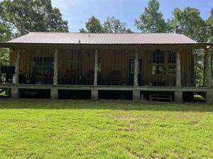 Whether you're looking for a rustic escape or your very own piece of paradise, this is it! There are 2 BRs, bath, living room, kitchen & laundry on main level another BR and bath upstairs. Approx 65 acres to enjoy the wildlife, fish in the pond or do some hunting. There is also another building for storage or make it a guest house. About a 10 minute drive & you are at Greers Ferry Lake. Some of the furnishing in the cabin will convey. Internet access, city water. 63 of the acres are fenced with bobwire.