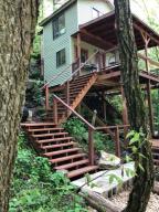 In the event you've been looking for that one of a kind special place, look no more. This cozy cabin overlooking your own spring branch. Call Today!