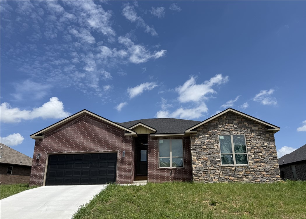 Welcome to your wonderful and very comfortable new home in Cave Springs, the jewel of Northwest Arkansas. This amazing brick and rock home has an awesome open floor plan with four bedrooms, two full baths and walk-in closets in 3 bedrooms. Many custom features include ceiling fans, granite counters, tall ceilings, lighted mirrors, a utility sink, and oversized windows that  let you see the sky, extra storage, security lights, LED lighting. The gourmet kitchen has cabinets to the ceiling, a spice rack, soft close hinges, 2 pantries, large drawers, a tip tray, pull out trash cans and a wine rack. Level fenced backyard with huge covered patio. Don't miss the opportunity to live in the center of Northwest Arkansas in a fantastic family friendly neighborhood. Easy access to i-49, Wal-Mart Home Office J B Hunt, Promenade Mall, restaurants and schools. XNA National Airport is only a few minutes away.