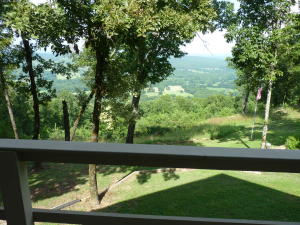 3 bed, 2 bath home on over 9 acres! Office could be 4th bedroom. Granite counters, crown molding, rock walls and OUTSTANDING VIEWS from inside and outside on deck across back of home. Very peaceful,private setting. 2 car garage includes cabinet storage and utility sink. Storage building, RV canopy, landscaped yard. basement storage.  9' ceilings help give this wonderful home a light and airy fee