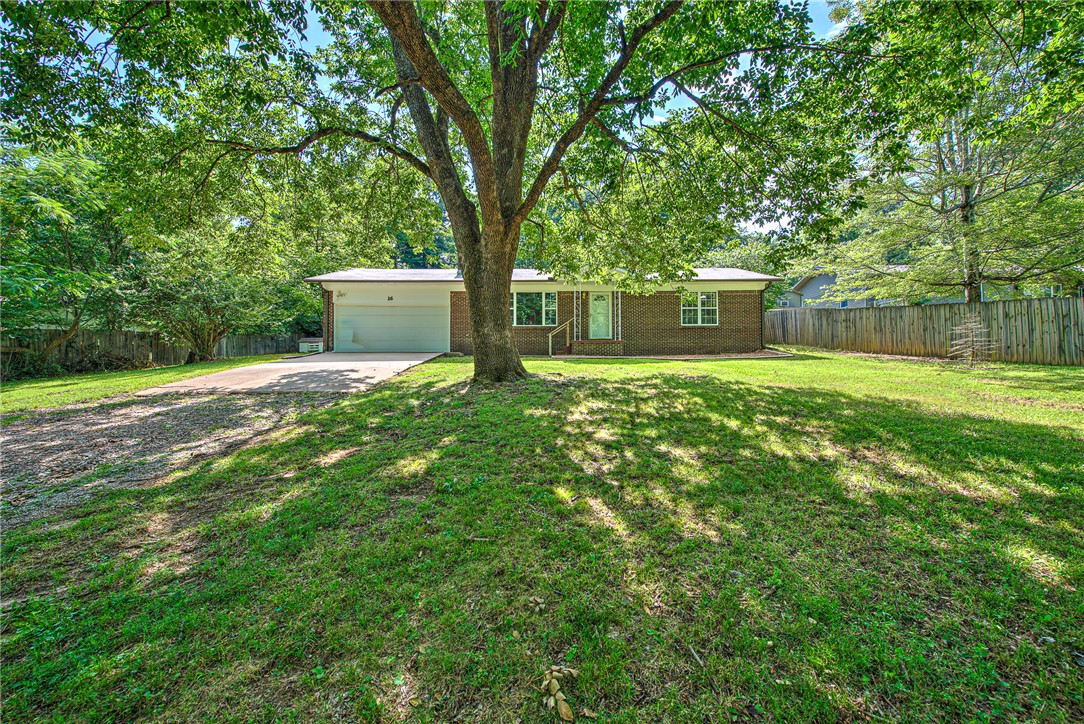 A charming property tucked in a shady hillside neighborhood. Nestling a beautiful home filled with natural light, a wood fireplace, updated kitchen and bathroom (2025) plus a bonus sunroom to enjoy the relaxing moments of life. Offering a simple floor plan with two bedrooms, organized efficiency closets an updated spacious bathroom. The backyard is large for a lovely garden and partly shaded for entertaining. The perfect location with two parks within 5 minutes, including the lovely West Fork Riverside Park. Downtown Fayetteville is only 15 minutes, Harps & DG Market less than 5 minutes. Available for showings!
