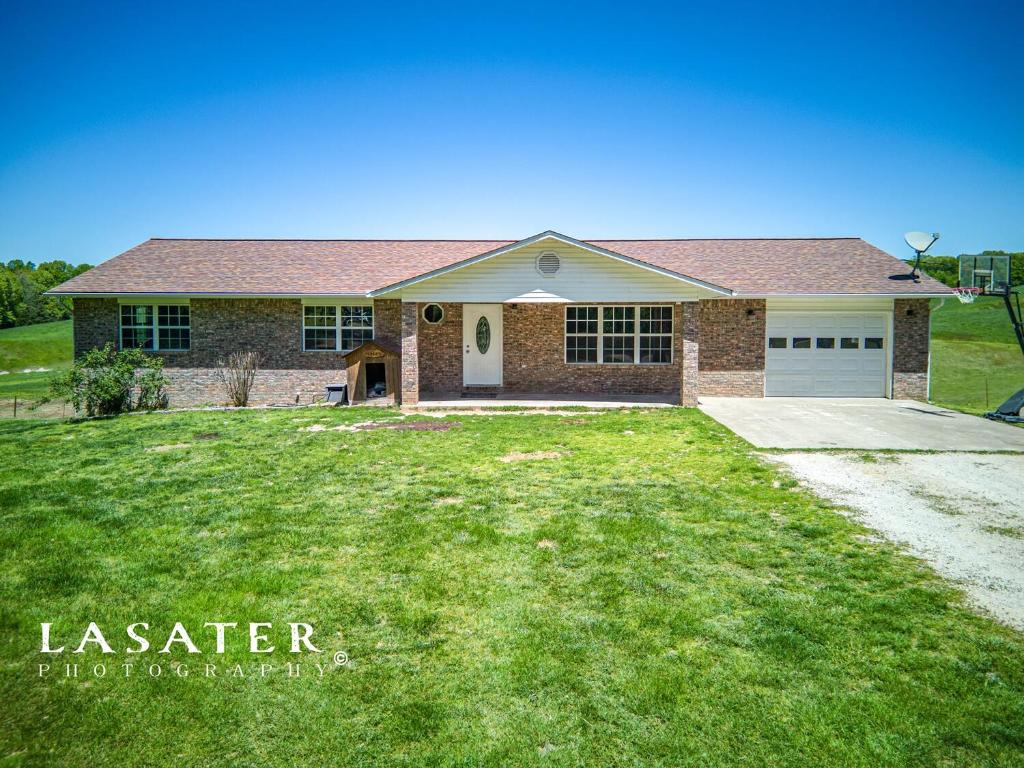 Country living at its best!  Custom built, all brick home with 3, 4 or 5 bedrooms and 3 full bathrooms with more than 3,000 square feet of living space!   Some of the upgrades include interior painted in 2024, new roof 2019, new hot water heater 2022 and new flooring 2020!  Other features include a solid concrete storm shelter built into the basement garage, 2 separate garages and workshop space, jacuzzi bathtub in primary bath, back up gas heat source, full walkout basement, office, large walk in pantry, family room and living room, large utility room, tons of cabinet space in the kitchen and views that will melt your stress away from the back deck.  Pride of ownership shows in this home from the moment you walk in the door! Bergman Schools.
