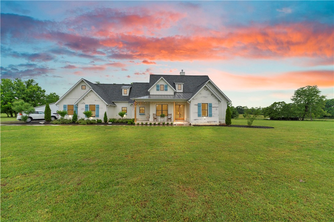 Your next home belongs in a magazine! Situated on five flat acres just minutes from town, this one-owner custom home offers the perfect blend of luxury, comfort, and functionality. Thoughtfully designed and meticulously maintained, every detail was carefully selected for warmth and character. Featuring four bedrooms, three and a half baths, a spacious living room, cozy hearth room, and additional sitting room, the floorplan is both fresh and inviting. The stunning office with custom built-ins and the dream kitchen with a butler’s pantry add even more charm and function. Outside, enjoy gorgeous curb appeal, peaceful country views, and a spotless 2,000-square-foot shop with a porch perfect for rocking chairs and quiet evenings. A rare combination of acreage, craftsmanship, and convenience this is more than a home, it’s a lifestyle.