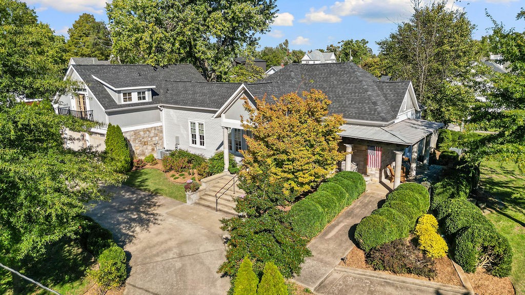 Rich in character & charm, this quintessential Bentonville gem feels like a warm hug. Just three blocks from the vibrant town square & steps to Crystal Bridges/Compton Gardens trailhead, this location is unbeatable. Easy access to Coler trails, Walmart campus & the Arts & Market District. Timeless details abound: a buttercream palette, original wood floors & trim, 11-foot & vaulted ceilings, French doors, & two original fireplaces. A thoughtfully designed addition features private second-level owner’s suite w/cozy office nook, kitchenette & Juliette balcony. Dreaming of a bed & breakfast? With 3 ensuite bedrooms, this home is ideal. Main-level suite w/its own entrance, porch & ramp for accessibility & privacy. Custom chef’s delight kitchen w/tumbled marble backsplash, granite counters, classic Aga range & butcher block island. Upstairs, discover whimsical bonus spaces, a full bath & the cutest attic nooks you’ve ever seen. Outside, enjoy lush back gardens, covered patio & porch & a gym/ADU space-to use as you wish!