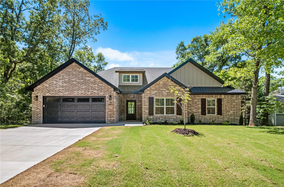 New construction on a large .39 acre wooded lot down the street from the Flo Ride Trail Crossing and provies easy access to Lake Ann! Step inside to discover an inviting open concept design featuring beautiful floors that enhance the spacious feel of the home. The stylish kitchen is equipped with a gas range, 3 cm quartz countertops, custom cabinets, and a walk-in pantry. Entertain or unwind in the living area, complete with a stunning fireplace, or step out onto the HUGE COVERED PATIO to enjoy the peaceful surroundings. The primary suite features a large walk-in tile shower and closet. Bentonville schools! Buyer can receive $3,500 in closing costs when using the builder's preferred lender!