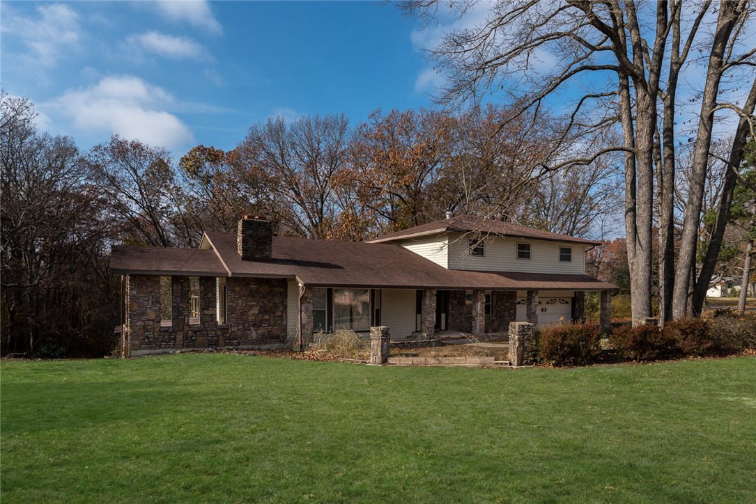 This charming home sits on over 1 acre of secluded land with over 5,000 sq ft and 3 levels.  Large living area boasts wood burning fireplace with access to covered patio.  Upgraded office features wood flooring, gorgeous built-in cabinets & well-lit glass shelving.  Spacious kitchen offers wood floors with plenty of cabinets & countertop space. One bonus room off of the entry with built-in bookcases and cabinets. Basement has a large area with large rock fireplace, built in mirrors and glass shelving that would be perfect for a dance studio or workout room, & another bonus room w/ plush leather wet bar and access to the patio as well serves a great entertaining room for guest!  Home also features an extra 1 car garage on the lower level with workshop. Home is also wired w/ ADT burglar alarm system.  Feel free to relax and enjoy nature from the privacy of your own home. Call today to schedule your showing!