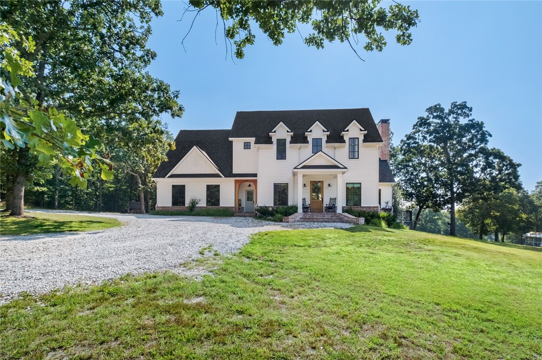 Stunning country estate featuring a 3661 square foot craftsman farmhouse sitting on 53.45 rolling acres with a fully stocked pond. Custom built in 2019 with great attention to detail, including designer lighting and smooth drywall. An abundance of natural light flows from formal dining with barn doors to living room with vaulted ceiling & wood burning fireplace. Gourmet kitchen with island & separate full pantry. Enter from friend’s entry or 3 car garage into mud area with built-in cubbies & utility room with drying shelves & dutch door. Private main level primary bedroom with elegant bathroom & walk-in closet. Upstairs features 3 bedrooms, 1 ensuite bath, 1 Hollywood with double sinks, bonus room with built-ins, and attic storage. Incredible covered back porch with swing & nightly views of wildlife. New in-ground pool. Home generator, security system with cameras, central vac. Custom barn with mini split system could easily be finished for guest quarters. Additional well on property.