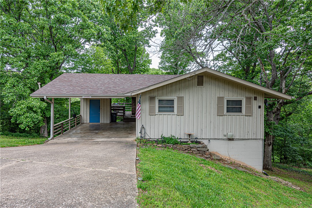 INCOME GENERATOR! This 3 bedrm 2 bathrm home with Tunnel Vision Trail access is minutes away from golf course, shopping, & eateries, offering direct access to one of Northwest Arkansas’ premier destinations! Operating as an AirBnb/VRBO this home comes FULLY FURNISHED (Including appliances & electronics) & is turnkey ready for your take over! Floor plan features:  covered carport w/ outdoor storage, open concept living & dining w/  gas log rock fireplace, LVP flooring, and large deck. Kitchen w/ floating wood shelves, stainless steel appliances, & tile backsplash! Relax in the primary suite with a private ensuite! Enjoy two addt’l bedrooms & addt’l full bathrm. Three-quarter wraparound deck overlooks the lawn and is surrounded by the mature trees of Bella Vista with trail access downhill from the property! ADDITIONAL FEATURES: Newer Roof (23’), Gutters & Downspouts, Newer Vinyl Windows, TVs in all bedrms! AirBnB (Super Host) & VRBO (Premier Host) 5 Star Reviews transferrable to new owner! Don’t Miss Out! Act Now!