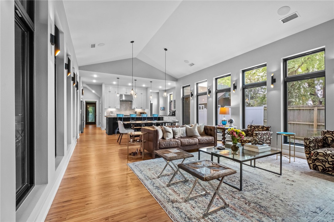 Luxury living in the heart of Bentonville at 715 NW 8th St—just 1 mile from Bentonville Square with quick access to dining, shopping & trails. Built in 2020, this 3,280 sqft home offers 4 beds, 3.5 baths, & a private flag pole-shaped lot. Vaulted living room with dual-sided windows and privacy tint fills the space with natural light. Chef’s kitchen features a large prep island & oversized pantry. Flexible bonus space off kitchen ideal for theater, or office leading to a fully enclosed sunroom. Enjoy outdoor living on the 26x8 covered porch with retractable screens. Main-level primary suite with spa-like bath & walk-in closet. Durable eucalyptus flooring & Anderson windows throughout. Upstairs includes loft/second living area, 3 bedrooms (1 with ensuite). Private yard offers space to design a custom outdoor retreat or pool—rare for newer construction so close to Downtown Bentonville. 3 schools within 1/2 mile. No POA, modern design, functional layout, turnkey, low-maintenance & move-in ready.