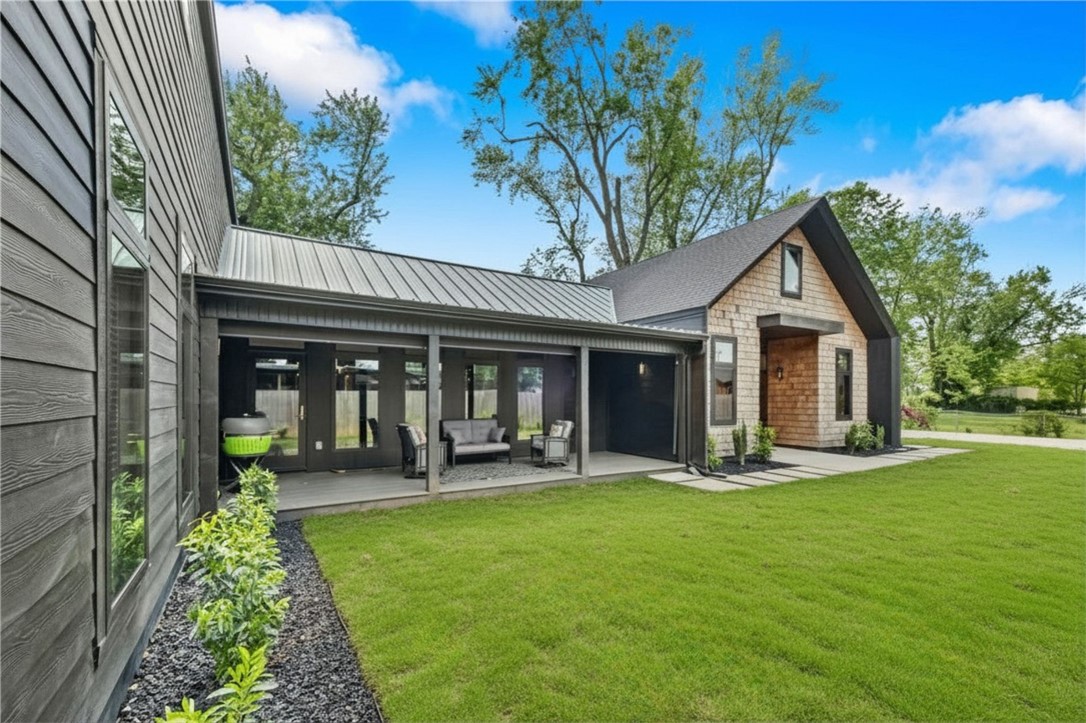 Luxury living in the heart of Bentonville at 715 NW 8th St—just 1 mile from Bentonville Square with quick access to dining, shopping & trails. Built in 2020, this 3,280 sqft home offers 4 beds, 3.5 baths, & a private flag pole-shaped lot. Vaulted living room with dual-sided windows and privacy tint fills the space with natural light. Chef’s kitchen features a large prep island & oversized pantry. Flexible bonus space off kitchen ideal for theater, or office leading to a fully enclosed sunroom. Enjoy outdoor living on the 26x8 covered porch with retractable screens. Main-level primary suite with spa-like bath & walk-in closet. Durable eucalyptus flooring & Anderson windows throughout. Upstairs includes loft/second living area, 3 bedrooms (1 with ensuite). Private yard offers space to design a custom outdoor retreat or pool—rare for newer construction so close to Downtown Bentonville. 3 schools within 1/2 mile. No POA, modern design, functional layout, turnkey, low-maintenance & move-in ready.