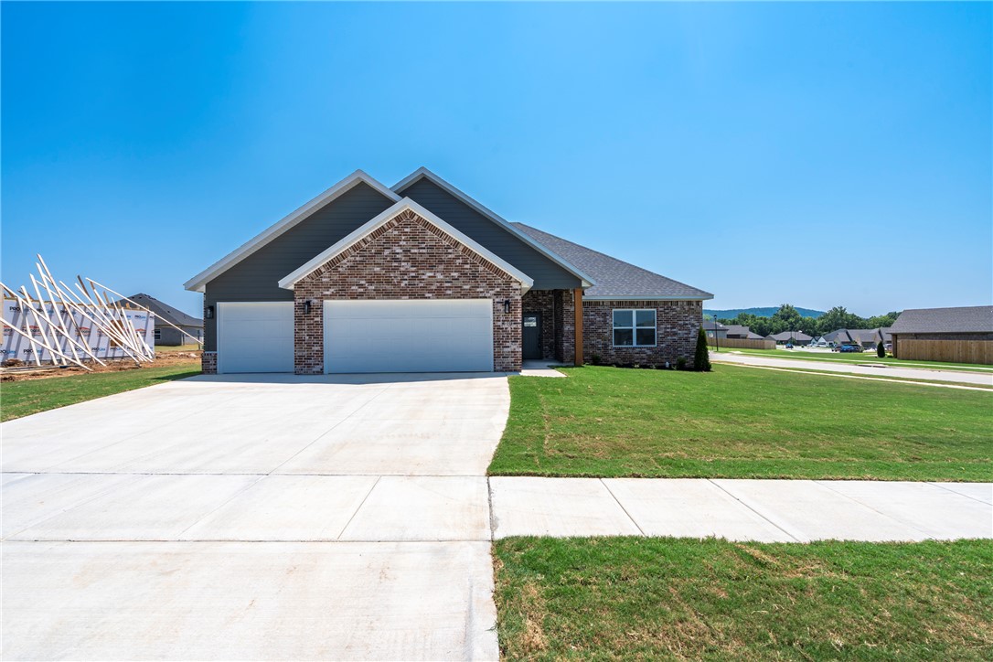New construction home offering an open floor plan with quality finishes throughout. The spacious living area features vaulted ceilings and a cozy gas fireplace flowing seamlessly into the kitchen and dining spaces. The kitchen is highlighted by white soft-close cabinetry, quartz countertops, stainless steel appliances and a large center island with seating. Durable LVP extends through the main living areas for both style and easy maintenance. The primary suite includes a tray ceiling and an ensuite with a double vanity, quartz counters, soaking tub, fully tiled walk-in shower and a generous walk-in closet. The laundry room offers additional cabinetry and counter space. Summerfield Subdivision is just around the corner from Creekside Park, a city park with trails and recreational amenities. This home also features energy-efficient construction designed for comfort and long-term savings.