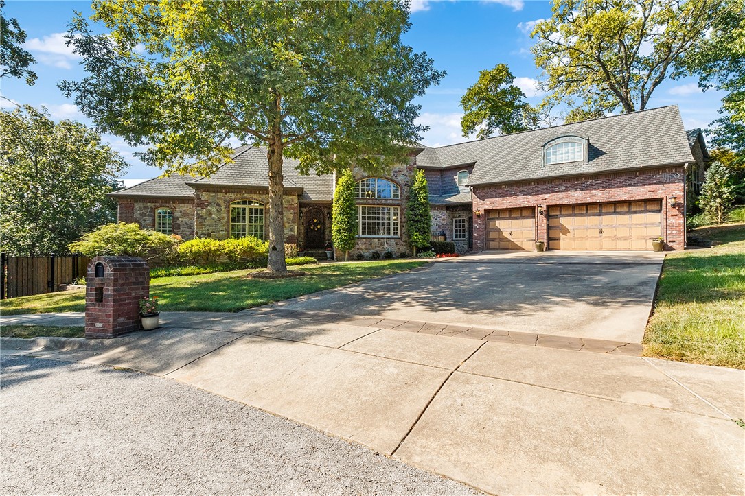 LUXURY LIVING WITH OUTDOOR OASIS JUST 3 MILES FROM DOWNTOWN BENTONVILLE AND .25 MILES FROM THE BIKE TRAILS! 
 
This luxurious European-style home sits on a quiet cul-de-sac and has a backyard retreat featuring a pool w/waterfall and grotto, outdoor fireplace, pizza oven, basketball sport court, hot tub, koi pond, and more! This incredible home features a main level master with a private deck, immense living area with fireplace and deck, full walk-out basement boasts a fireplace, living area, kitchen area, 2 bedrooms, wine cellar and custom-built sauna. Office displays built-ins and double doors, along with formal dining, 2 additional upstairs bedrooms, and so much more. The traditional design features detailed woodwork and custom archways along with thoughtful, colorful touches, making it a welcoming, cozy space to entertain and call home. If you’re an entertainer, this is the perfect house for you. This home is a must-see!