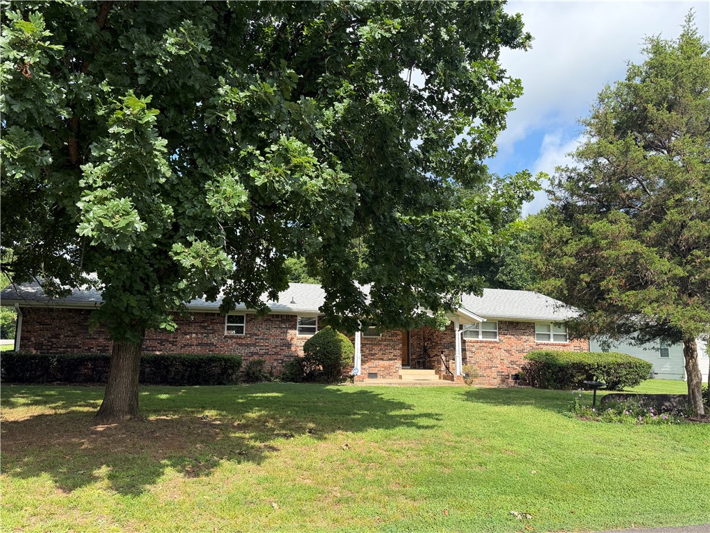 RARE OPPORTUNITY! First time on the market! Welcome to this custom-built, one-of-a-kind brick home  radiating with timeless character and masterfully crafted by a renowned builder. Nestled on a spacious corner lot, this 3-bedroom, 3-bathroom residence offers 2,048 sq. ft. of comfortable living space plus a delightful sunroom. Brand-new roof overhead! Best of all, the sale includes the adjacent vacant lot. Conveniently located near local parks, the hospital, and shopping within the Clarksville School District, this home is being sold as-is. Don't miss this beautiful, well-maintained dwelling. ONE OWNER RESIDENCE.