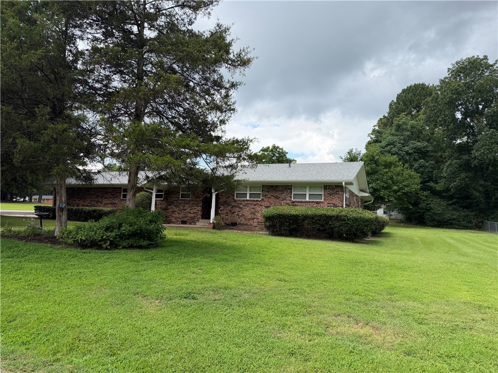 RARE OPPORTUNITY! First time on the market! Welcome to this custom-built, one-of-a-kind brick home  radiating with timeless character and masterfully crafted by a renowned builder. Nestled on a spacious corner lot, this 3-bedroom, 3-bathroom residence offers 2,048 sq. ft. of comfortable living space plus a delightful sunroom. Brand-new roof overhead! Best of all, the sale includes the adjacent vacant lot. Conveniently located near local parks, the hospital, and shopping within the Clarksville School District, this home is being sold as-is. Don't miss this beautiful, well-maintained dwelling. ONE OWNER RESIDENCE.