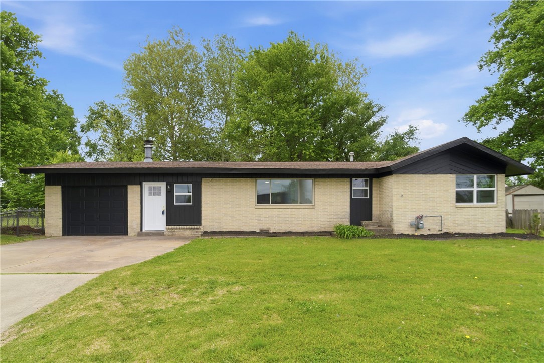 Completely refreshed inside and out, this charming 3-bedroom, 2-bathroom brick home in central Springdale is move-in ready and packed with upgrades. From top to bottom, the seller has invested in a new kitchen with quartz counters, new vanities and tiled bathrooms, new LVP and ceramic tile flooring, updated plumbing and lighting packages, new double-pane vinyl windows, and fresh paint throughout. The living room features a cozy wood-burning fireplace, and the eat-in kitchen offers everyday convenience. A 2022 HVAC system provides peace of mind. Outside, enjoy a private, fenced backyard shaded by mature trees, a patio perfect for entertaining, and a storage building. The attached carport/garage adds covered parking, and there's no POA. Located just minutes from Lake Fayetteville and the Razorback Greenway trail system, with quick access to I-49, shopping, dining, and all that NW Arkansas has to offer.