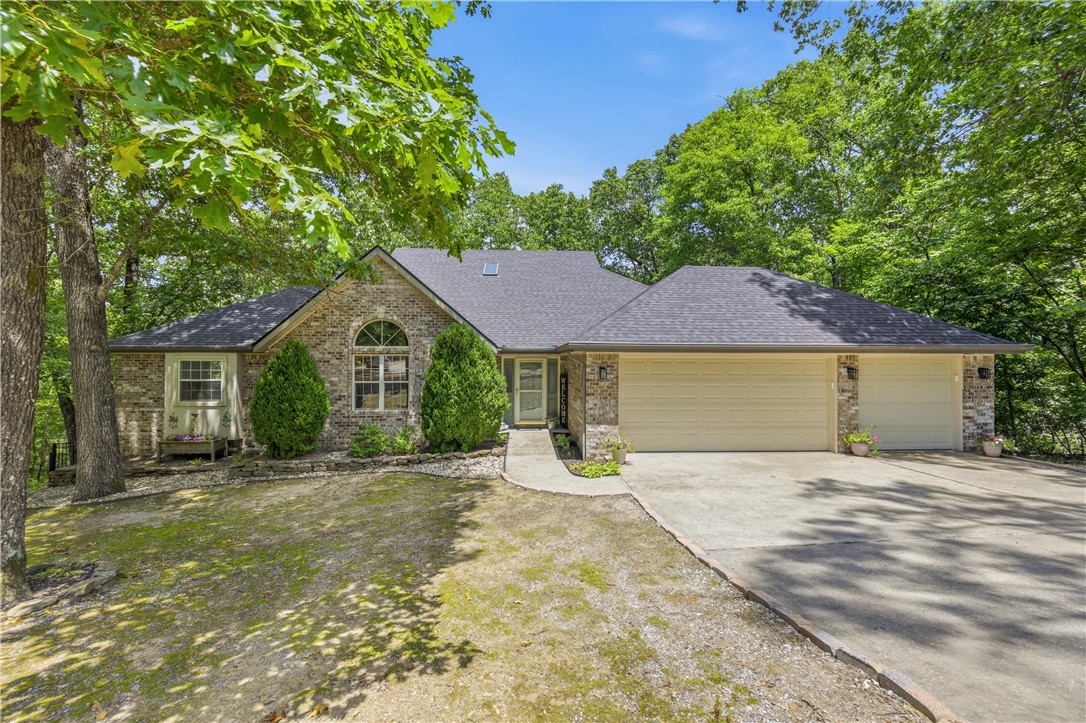 Tucked away in the beautiful Ozarks, this Bella Vista home was built for entertaining! Quietly situated at the end of a cul-de-sac on over 1.5 acres, you will absolutely love coming home every day. Your new home is literally seconds away from the best golf and biking in the area. You will pass by the exhilarating, brand-new, OZ Trails Bike Park every time you drive home. 4 bedrooms, 3.5 bathrooms, and a 3 car attached garage. Vaulted ceilings, hardwood flooring, and granite countertops are some of the additional upgrades you will love in your new place. Entertain your guests inside or out: treat them to a party in the basement as you pull up a barstool at the wet bar, or hang out on the two-level deck or covered patio. Relax the nights away in the included hot tub on the deck, by one of two fireplaces, or gather in the completely remodeled kitchen. Go to bed with peace of mind knowing that your included generator will keep the power on during and after storms. Call today for a personal tour!