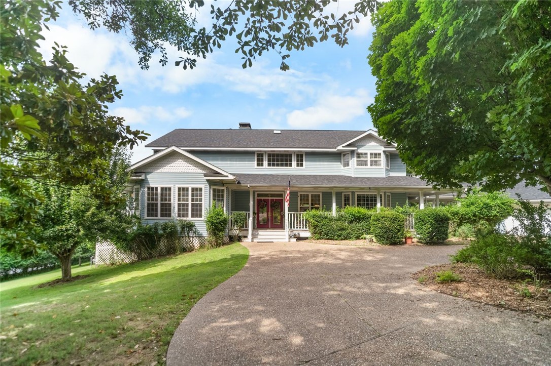 This exceptional three-story lakefront estate offers over 7,400 SF of living space, a private boat dock with 2 slips, and approximately 700 ft of pristine shoreline. Panoramic lake views are showcased throughout, creating a seamless connection to Beaver Lake from every room. All 5 bedrooms feature en-suite bathrooms and private exterior access, offering comfort, privacy, and convenience. 4 fireplaces add warmth and ambiance to multiple living and entertaining areas. Additional highlights include an insulated 3 car garage, generous storage, and thoughtfully designed indoor-outdoor living spaces
The backyard is a private oasis with expansive lake views, a covered patio, and a built-in grill with fridge—perfect for entertaining. A gentle, flat walk leads directly to the private boat dock. Peaceful and secluded, yet just five miles from Downtown Rogers, this rare property offers luxury lake living, blending tranquility with easy access to shops, dining, and local amenities. Don’t miss this opportunity on Beaver​​‌​​​​‌​‌​​​‌‌​​​‌‌‌​​‌​​‌‌​​​​ Lake