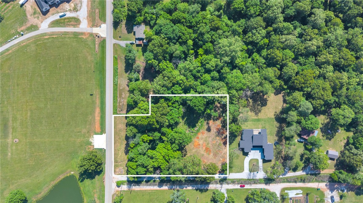 Tucked away in one of Tontitown's most convenient locations, this 2.35 acre property offers the perfect canvas to build your dream home. Approximately .7 acres of buildable space, while the remaining acreage unfolds into a wooded, sloping landscape that creates a natural buffer of privacy and a peaceful, tucked away feel. Utilities available at the road, septic needed, this property is ready for your vision. Whether you're looking to build now or invest for the future, this setting offers a rare mix of accessibility, space and seclusion just minutes from HWY 412, I-49 and nearby amenities.