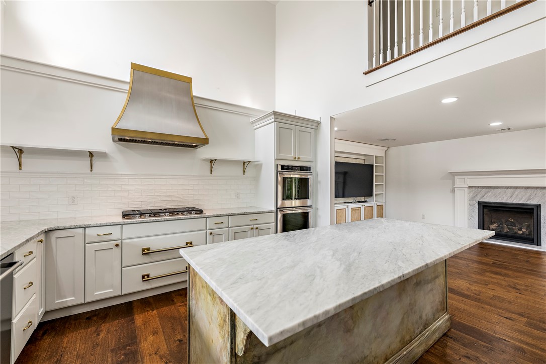 Located just a short stroll from the lively Bentonville Square, this exceptional home on an expansive corner lot is a showcase of style, sophistication, and thoughtful design. Bathed in natural light, the open-concept living area features rich wood flooring, custom built-ins, and a vaulted ceiling that soars above the chef’s kitchen, complete with upgraded appliances and ample workspace. The main-level primary suite offers a serene retreat, while upstairs, you’ll find two generously sized bedrooms with a shared bath, a third bedroom with an ensuite bath, and a versatile second living area that can serve as an office, playroom, or fitness space. Fresh paint, central vacuum, and a new custom carport designed to accommodate an RV or large vehicle elevate the home’s functionality. With its elegant finishes, spacious layout, and enviable proximity to Bentonville’s best dining, shopping, and cultural attractions, this home offers luxury living at its finest.