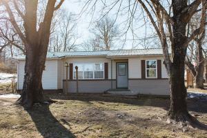 If you are looking for 3 bedroom 2 bath with a little land, fully fenced, plus outbuildings then this is it! This very clean home has a metal roof and newer tilt-out windows adorned with plantation blinds. It is decorated with exposed ceiling beams, dark wood trim, and wood and rock detailing on the walls. Guest bath has a beautiful tiled walk-in shower.  It sits on .73 acres and includes a large 30x50 insulated workshop with 220 electric. There is also a very nice smaller shed with concrete floor.  The landscaping includes chestnut, walnut and cherry trees. Enjoy the peace and quite at this place close to the Buffalo and close to Harrison.