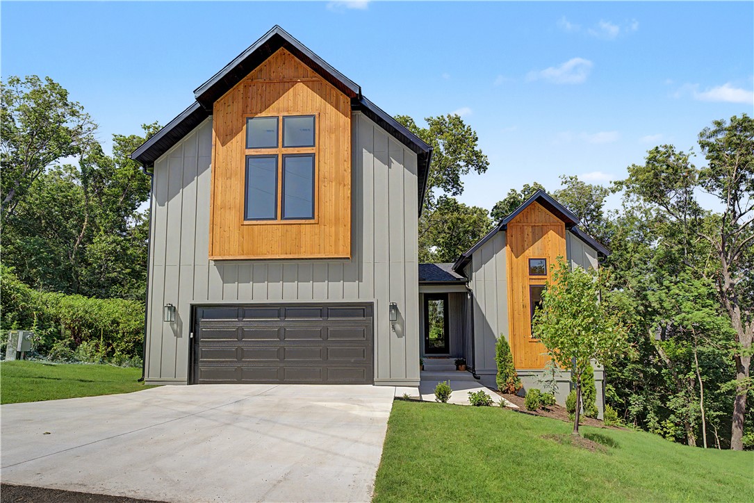 This  modern contemporary home has high-end finishes with a comfortable layout that everyone is asking for. You walk into 20' ceilings,and floor to ceiling windows that let in the natural beauty of the backyard and covered deck.  The large living room with fireplace to enjoy your evenings. The unique kitchen features black matt finish quartz counters and designer tile backsplash,with an extra counter for coffee bar or prep area.  The extra built-in cabinets along the side are a surprise addition.  The private master suite connects to a spa-like bath with dual sinks,custom shower and soaking tub.  The roomy closet has a window for extra light.  There is also a half bath powder room on the main level.  Laundry room and pantry are next to the garage entry.  The second floor has 3 bedrooms,full bath with dual sinks and a large bonus area for office or playroom. The 23x10 deck will be a great hangout place to enjoy nature.