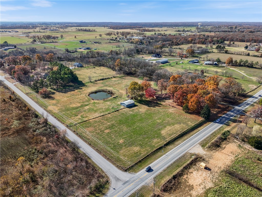 Located at the corner of Hwy 102 and Tycoon Rd, this prime Centerton property sits right in the path of rapid growth and development. It offers exceptional access and visibility with approximately 658 ft of frontage on both Hwy 102 and Tycoon Rd. Positioned just minutes from the future Centerton Community Center, the proposed Walmart Supercenter site, and only 10 minutes from the new Walmart Home Office campus, this location is ideal for commercial or residential projects. All major utilities are nearby, making it ready for your next development opportunity. Value is in the land and the house on the property is sold as-is/where is, but could be a great use for rental income in the short term. Unlock the potential of one of Centerton’s most promising corners.