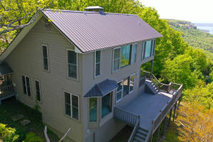 Live the lake life at Greers Ferry Lake in your own 2,510 square foot home with a 3 bedroom, 2.5 baths, living room, rock fireplace, sunroom and an office.  If you have been thinking about a lake property, this one has a ''MILLION DOLLAR VIEW'' of the water. Enjoy the privacy and beauty of the  2.49+/- landscaped acres with paved roads all the way to the property and a circular driveway making it easy to drive through or backing up a boat.  In the Diamond Bluff community of Greers Ferry Lake this property is conveniently located just 10  minutes to the Narrows park, 15 minutes into the town of Quitman and about 25 minutes to Heber Springs Arkansas.