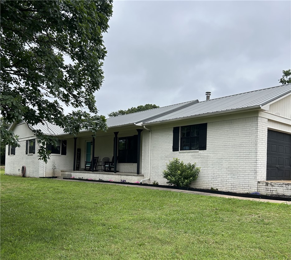 Beautifully updated brick home on approximately 10 acres. The property includes a 30' x 35' metal shop with 12' side walls, 200-amp electrical service, and 6" concrete floors, making it ideal for equipment, vehicles, or other projects. Property also includes pole barn and chicken coop.  Updates include new dishwasher and gas stove in 2023, new water heater installed in 2020, metal roof installed in 2016, HVAC replaced in 2001. Professional photos coming soon.