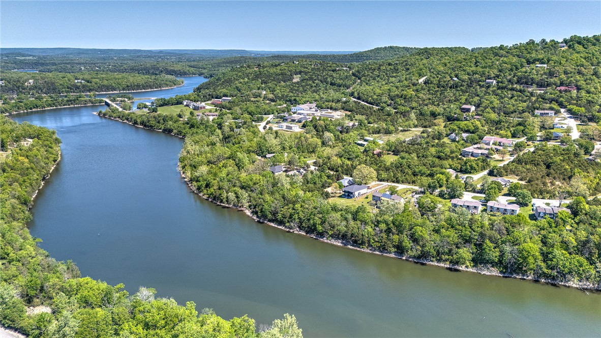 Enjoy lakefront living in this beautifully furnished waterfront condo in Holiday Island near Eureka Springs. Perfectly positioned for serene water views, this move-in-ready property offers comfort, convenience, and natural beauty. The open-concept living and dining area features abundant natural light and tasteful furnishings throughout. The spacious living room flows to a private deck/patio—ideal for morning coffee or relaxing evenings by the water. The kitchen is fully equipped for everyday living or entertaining, while the bedrooms provide comfortable retreats for owners and guests. Sold fully furnished, this turnkey condo is perfect as a full-time residence, vacation getaway, or income-producing rental. Located in the desirable Holiday Island community with access to golf, marina, trails, and just minutes from historic Eureka Springs.
Up to $5000 in Lender credits available
