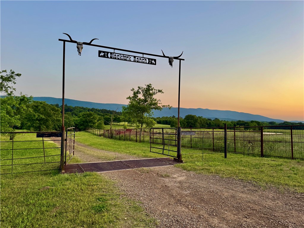 Hunting, cattle and recreational property with amazing views, exceptional hunting and fishing and is thoughtfully set up for cattle grazing and hay production with Black Fork River meanders through. Fenced and cross-fenced with multiple gated entrances. Adjacent to Black Mountain WMA. The home sits high atop a hill overlooking the property.