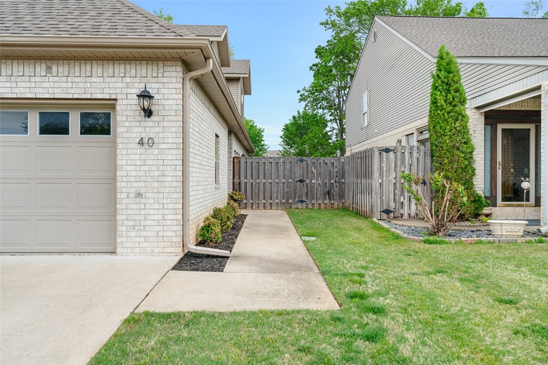 Welcome to this beautifully maintained 3 bedroom 2 bath condo offering approximately 1588 sqft of comfortable living space in the heart of Northwest Arkansas. This move-in ready home features an open floor plan filled with natural light, tall ceilings, and a cozy gas fireplace--perfect for both relaxing and entertaining. The designed layout provides a seamless flow between living, dining, and kitchen areas, creating a warm and inviting atmosphere. Step outside to enjoy a beautiful yard space, ideal for quiet mornings or evening gatherings. Located in a convenient, tree-lined neighborhood, this townhome is part of most recent building on the street, offering added peace of mind and modern appeal. Enjoy an exceptional location with easy access to medical services, shopping, dining and all that Northwest Arkansas has to offer. Just minutes from Dickson Street, U of A, and Fayetteville Square and only 25 minutes to Crystal Bridges. Don't miss this opportunity to own in one of the area's convenient locations!
