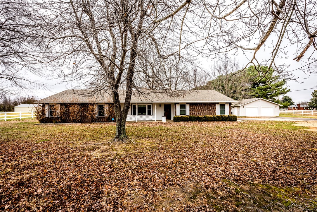 Beautiful property on 4.95 Acres! 4 BD, 2 BA, 4 Car Garage! This home features a large yard with white split rail fencing, beautiful laminate wood floors, a large updated fireplace, a large eat in kitchen with a bay window, a large kitchen with updated cabinets, a large laundry room with lots of storage, a mud room with storage, spacious bedrooms, and large bathrooms with vanities!! This home has an extra 2368 SqFt of storage all with shelving on the land!
