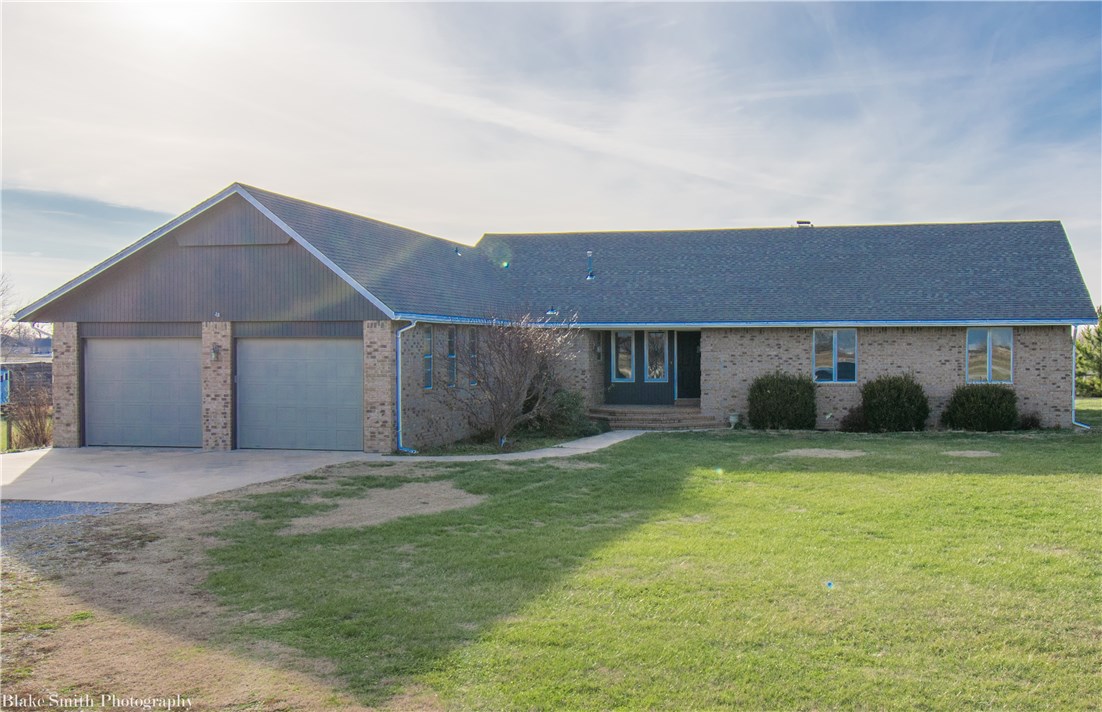 Beautiful brick country home sitting on 1.95 acres!  Kitchen recently updated with granite counters, white cabinets, & new appliances.  Home features stunning sunset views from the oversized deck, new floors throughout, new roof, 4 large bedrooms, wet bar, Anderson windows, 3 full baths, large living area, storage building, play set, outbuilding that could easily be turned into separate guest quarters, and much more!  Property is flat and surrounded by pine trees for even more privacy!