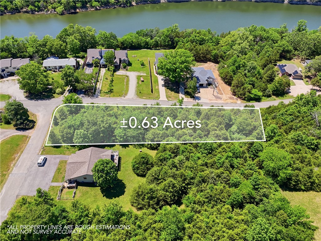 Looking for a walking trail to the lake? You have found it! Leatherwood Trail has been designed to lead you right to the water's edge and is right across the street from this property! Corner lot with primary road frontage is zoned for Duplex structures. This could be the perfect opportunity to build a beautiful lake area/view setting.  Almost an acre of level landscape, with green mature trees for plenty of privacy.  This property is extremely close to the marina, Recreation Center with community pools, pavilion, golf course and playgrounds! Explore and enjoy the opportunities of Holiday Island!