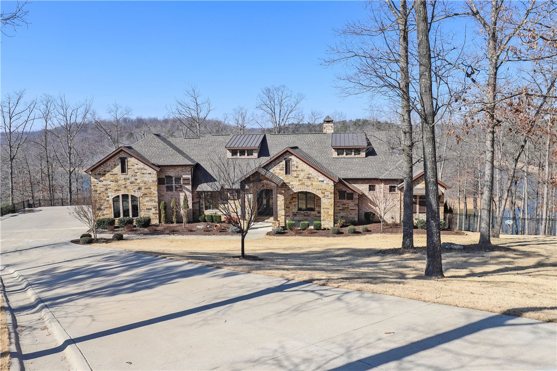 CUSTOM BUILT LAKEFRONT ESTATE OFFERING GORGEOUS LAKE VIEWS & PRIVATE 2 SLIP BOAT DOCK!  Beautiful 2.60 acre setting w/easy access to lake & dock!  Spacious screened deck & huge lower patio w/hot tub & fire pit!  The stunning interior offers top of the line amenities throughout including wood flooring, knotty alder cabinetry, granite, custom wall finishes, high ceilings w/ rustic beams and large picture windows offering fabulous views!  Walk-out basement w/bonus, bed, full bath!  Don’t miss this PRISTINE custom estate!!