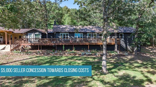 If you've been dreaming of wide-open space without sacrificing convenience, this is the one. Nestled at the end of a private drive on 5 park-like acres — half open, half wooded — this 4-bedroom, 3-bath ranch feels like a retreat, but sits just minutes from Fayetteville and Elkins schools. The open floor plan keeps everyday living easy, while the back patio and deck are made for the kind of slow mornings and easy evenings that remind you why you wanted land in the first place. A metal roof, propane range, built-ins, and a pantry mean the practical details are already handled. The attached workshop and 390 sq ft outbuilding give you room to work, store, or tinker. With 2,265 sq ft, a 3-car carport, and no flood zone concerns, this property checks every box — and then some.