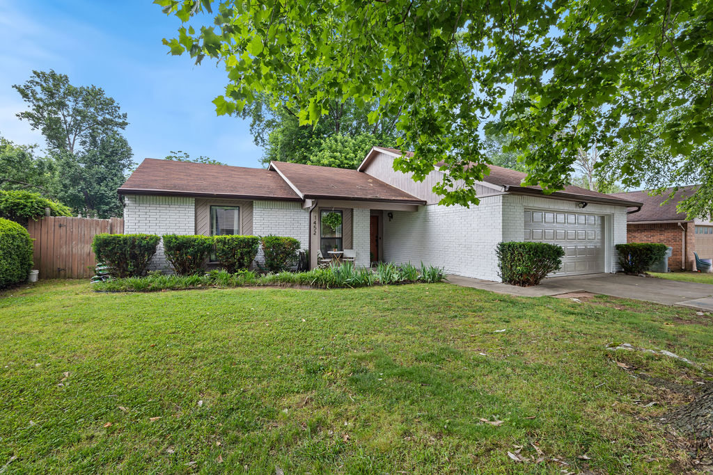 Location, charm, and a sunroom you may never want to leave! Fantastic Fayetteville location just minutes from restaurants, shopping, and trails! Nestled in an established neighborhood with mature trees & sidewalks, this home offers an easy walk to the elementary school.  Inside, the spacious living room features a beamed ceiling, recessed lighting, and a cozy wood-burning fireplace. The kitchen is functional & inviting with an eat-at peninsula, granite countertops, and tons of cabinets. A standout feature is the fabulous enclosed patio with cathedral ceiling & floor-to-ceiling windows...a perfect space for dining, relaxing, or entertaining year-round. The peaceful backyard includes a large patio for fun gatherings, plus a spacious storage shed. New carpet has just been installed, and a brand-new roof is being added next week!