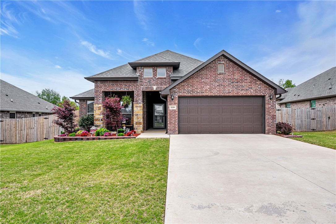 Welcome to 5339 Clear Springs Ave in Springdale's sought-after Deere Creek subdivision! This 2023-built, all-brick Craftsman home is move-in ready and shows like new. With 3 bedrooms, 2 bathrooms, and 2,059 sq ft, enjoy a split floor plan, cathedral ceilings, and granite countertops. The kitchen features a gas range, built-in microwave, dishwasher, pantry, and soft-close cabinets. The primary bath boasts a one-piece marble shower. Higher-grade insulation keeps energy costs low year-round. Relax by the electric fireplace or unwind on the covered patio in a fenced, landscaped backyard. A 2-car garage plus 120 sq ft storage building offer plenty of room. Walk-in closets, double-pane windows, ceiling fans, and a programmable thermostat round out the comfort features. Conveniently near shopping, hospitals, and I-49. Schedule your showing today!