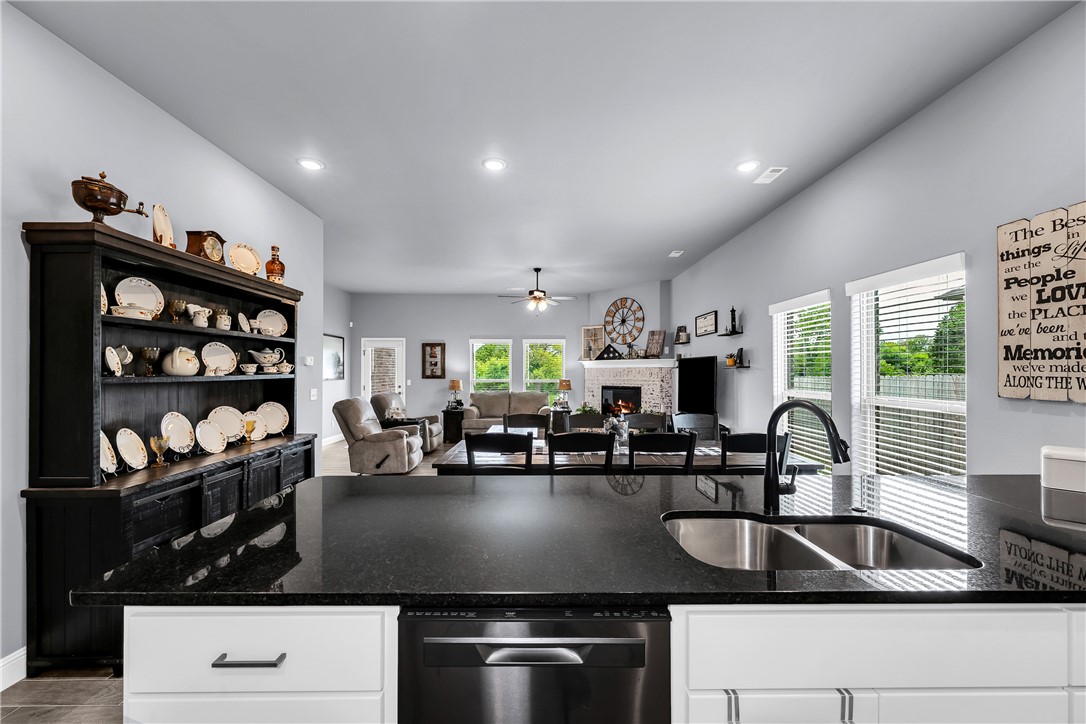 Welcome to 5339 Clear Springs Ave in Springdale's sought-after Deere Creek subdivision! This 2023-built, all-brick Craftsman home is move-in ready and shows like new. With 3 bedrooms, 2 bathrooms, and 2,059 sq ft, enjoy a split floor plan, cathedral ceilings, and granite countertops. The kitchen features a gas range, built-in microwave, dishwasher, pantry, and soft-close cabinets. The primary bath boasts a one-piece marble shower. Higher-grade insulation keeps energy costs low year-round. Relax by the electric fireplace or unwind on the covered patio in a fenced, landscaped backyard. A 2-car garage plus 120 sq ft storage building offer plenty of room. Walk-in closets, double-pane windows, ceiling fans, and a programmable thermostat round out the comfort features. Conveniently near shopping, hospitals, and I-49. Schedule your showing today!