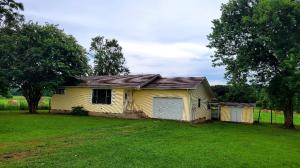 Cute Country Home! This house is sitting down a short dirt road with pasture living all around! This has been a great rent house and can continue to be or can be a great home for anyone ready to settle down! With 2 bedrooms and large living room and a sunroom on the back to enjoy your morning coffee while watching the neighbors cows graze! Did I mention Country! Call today for your showing! SQFT taken from county records. Built in 1989 per owner.